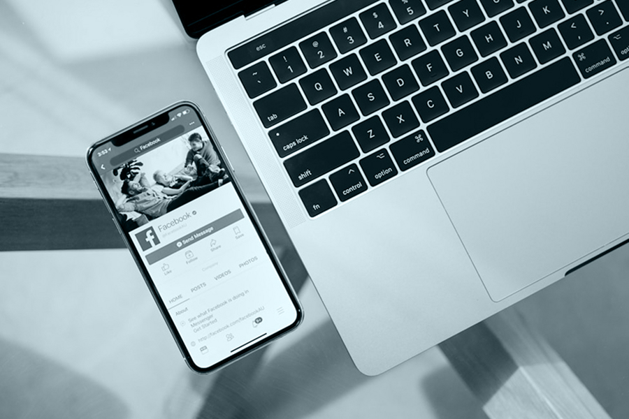 A phone and laptop on a desk