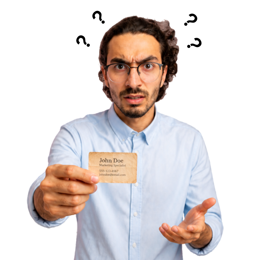 A confused man holding out an old business card